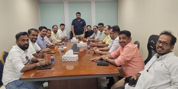 Dubai KMCC Kozhikode District Committee members meeting to discuss UDF election campaign and "Vote Flight" initiative in Dubai office.
