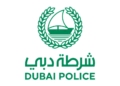 Dubai Police logo and security personnel at Dubai International Airport transit terminal