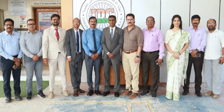 Consul General Satish Kumar Sivan handing over RAK crematorium site plan to Indian Relief Committee leaders.