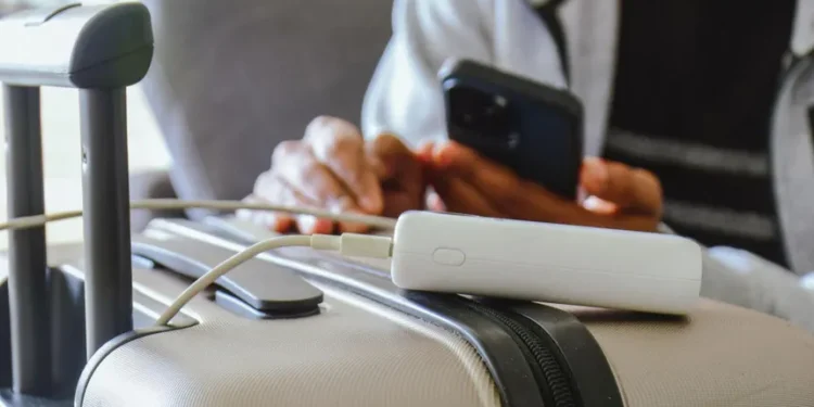 Cabin crew inspecting power bank baggage regulations before passenger flight boarding