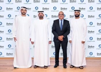 Passengers shopping at Dubai Duty Free counter with digital payment options available