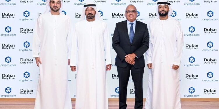 Passengers shopping at Dubai Duty Free counter with digital payment options available