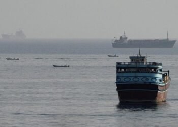 Commercial cargo vessel navigating near the Strait of Hormuz maritime passage.
