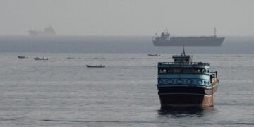 Commercial cargo vessel navigating near the Strait of Hormuz maritime passage.