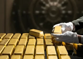 Gold bars and coins displayed in a Dubai gold souk window.
