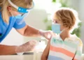 Healthcare professional administering routine vaccination to a primary school student in the UAE