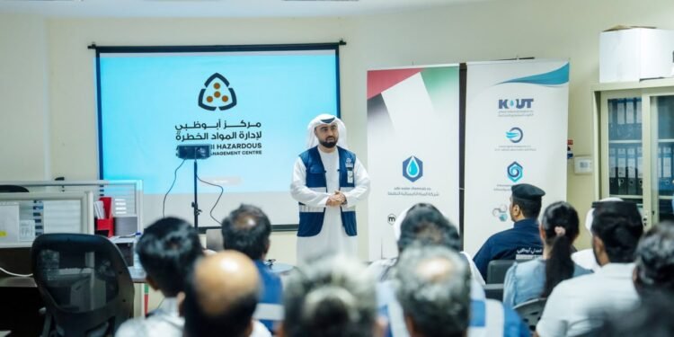 Abu Dhabi Civil Defence officers instructing industrial workers on hazardous materials handling and safety equipment.