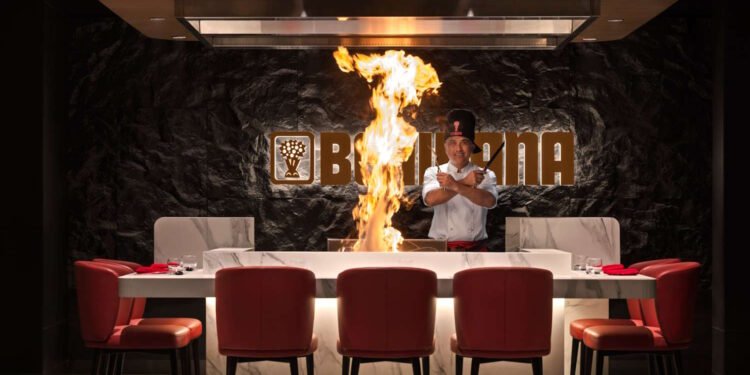 Chef performing live teppanyaki cooking at Benihana Ibn Battuta restaurant Dubai