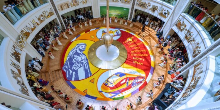 Healthcare workers at Burjeel Medical City standing around a 250-square-meter floral carpet featuring UAE President Sheikh Mohamed bin Zayed Al Nahyan.