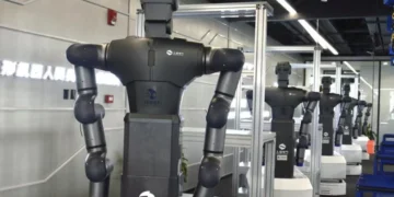 Humanoid robot undergoing motion capture training inside a simulated work facility in Hangzhou, China.