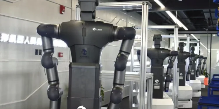 Humanoid robot undergoing motion capture training inside a simulated work facility in Hangzhou, China.