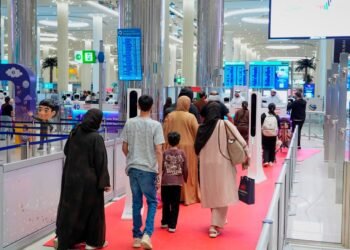 Passengers completing automated immigration clearance at Dubai Airport smart gates