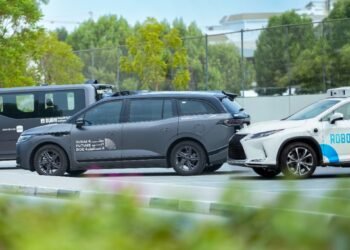 Baidu Apollo Go autonomous Robotaxi driving on a street in Dubai, UAE