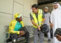 Dubai RTA official distributing health kit to motorcycle delivery rider during summer safety drive