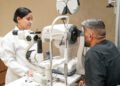 Optometrist conducting a digital eye test for a driving licence applicant in Dubai.