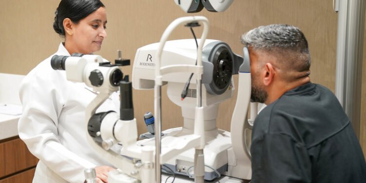 Optometrist conducting a digital eye test for a driving licence applicant in Dubai.