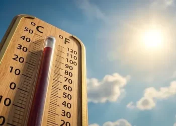 Digital weather board displaying extreme high summer temperature in UAE desert landscape