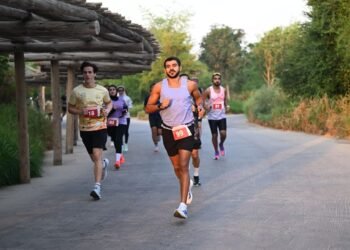 Runners taking part in an outdoor community event with Sharjah Safari nature reserve in the background